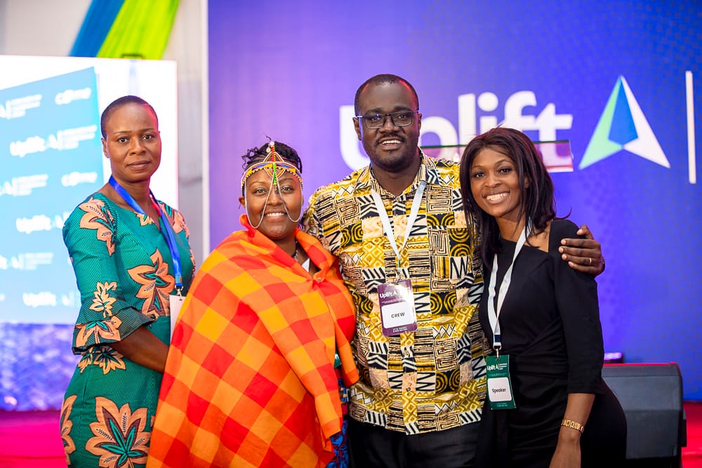 A young person sits on wooden stairs with an open book, reading or studying.